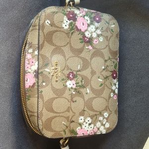 Coach cross body purse with beautiful floral design all over.